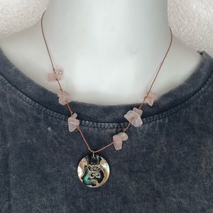 Pink stones on a thread with a butterfly charm.